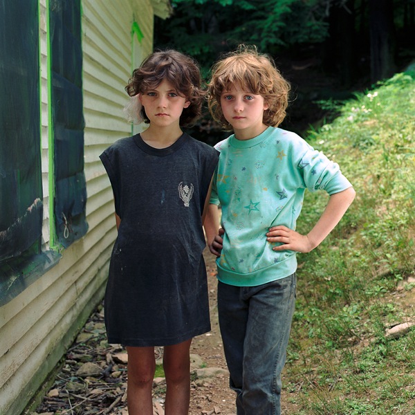 Young Girls standing next to house