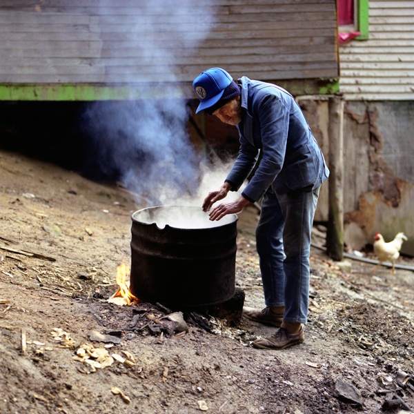 Man Warming hands near fire