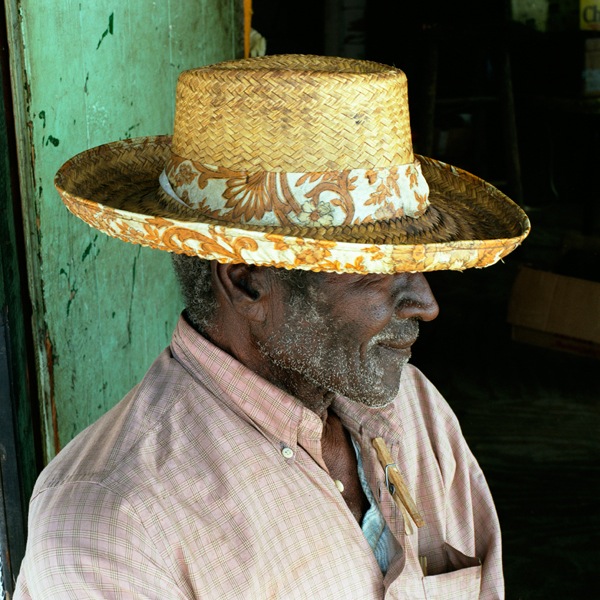 Elder Man seated outside with cane